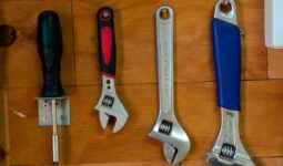 a bunch of tools are hanging on a wall